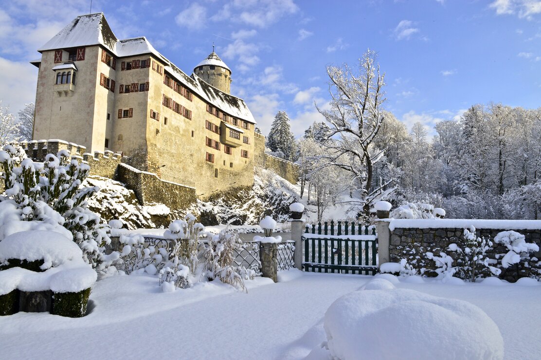 Auf dem Bild sieht man das Schloss Matzen und den darunterliegenden Park mit Schnee bei schönem Wetter. | © Alpbachtal Tourismus | Bernhard Berger