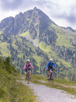 Paar fährt mit Bikes Forstweg Greiter Graben Alpba | © Alpbachtal Tourismus